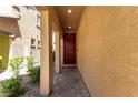 Inviting entryway with a dark red door, leading into this beautiful home at 10086 Adina Ct, Las Vegas, NV 89141