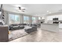 Spacious living room featuring neutral colors, an overhead fan and an attached dining area at 10086 Adina Ct, Las Vegas, NV 89141