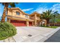 Inviting two-story home with a spacious driveway leading to a three-car garage and a manicured lawn at 10798 Tapestry Winds St, Las Vegas, NV 89141