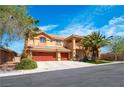 Beautiful home with a three-car garage, mature palm trees, a balcony, and well-maintained landscaping at 10798 Tapestry Winds St, Las Vegas, NV 89141