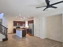 Open-concept living room and kitchen with modern fixtures and design at 11298 Corsica Mist Ave, Las Vegas, NV 89135