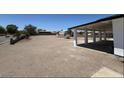 Large, open backyard with gravel landscaping and a covered patio, perfect for outdoor activities and entertaining at 1227 San Gabriel Ave, Henderson, NV 89002