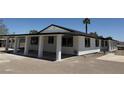 Side view of white home with black trim, many windows and large, covered patio space at 1227 San Gabriel Ave, Henderson, NV 89002