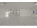 Spacious living room with marble floors that flows into the kitchen and includes a modern front door at 1227 San Gabriel Ave, Henderson, NV 89002