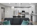 Stylish kitchen with white cabinets, granite countertops, and an island with seating at 12525 Lylan Ridge St, Las Vegas, NV 89138