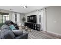 Cozy living room with hardwood floors, modern furniture, and natural light at 12525 Lylan Ridge St, Las Vegas, NV 89138