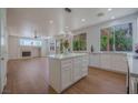 A modern kitchen with an island, stainless steel appliances, and a view of the backyard at 1371 Cumulus Ct, Henderson, NV 89014