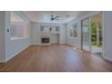 Bright living room featuring wood floors, a fireplace, and sliding doors to the backyard at 1371 Cumulus Ct, Henderson, NV 89014