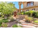 Beautifully landscaped front yard with stone steps leading to the home, offering a grand entrance at 1737 Cypress Manor Dr, Henderson, NV 89012
