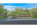 View of the Eagle Hills community entrance with lush greenery and blue sky at 1809 White Hawk Ct, Las Vegas, NV 89134