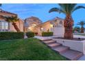 Well-maintained home featuring a two-car garage, tile roof, and desert landscaping at 1913 Madagascar Ln, Las Vegas, NV 89117