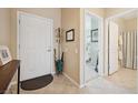 Welcoming foyer with tiled floors, white door and trim, and seamless transition to other living spaces at 2453 Vivid Sky Pl, Henderson, NV 89044