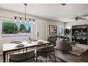 Bright, staged living and dining area with modern decor and a large window providing natural light at 280 Gentry St, Overton, NV 89040