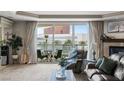 Inviting living room with balcony and palm tree views, cozy fireplace, and comfortable seating at 2857 Paradise Rd # 401, Las Vegas, NV 89109