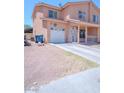 Two-story home with covered porch, white garage door and easy to maintain desert landscaping at 2906 Cedar Ave, Las Vegas, NV 89101