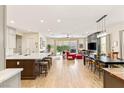 Open floor plan integrates the kitchen, dining, and living areas seamlessly, offering ample space and access to the outdoors at 3395 Stone View Ave, Henderson, NV 89044
