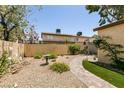 Backyard featuring decorative gravel, artificial turf, pavers and stone bird bath at 3890 Lancome St, Las Vegas, NV 89115
