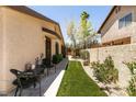 Exterior view of home featuring tidy walkway, small table, and lovely flower garden at 3890 Lancome St, Las Vegas, NV 89115