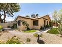 Home exterior featuring decorative rock and gravel, pavers and artificial turf at 3890 Lancome St, Las Vegas, NV 89115