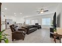 Spacious living room features tile floors, recessed lighting, and is adjacent to the kitchen and dining area at 392 Canary Song Dr, Henderson, NV 89011
