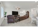 Comfortable living room with tile floors, features a large television and an open floor plan at 392 Canary Song Dr, Henderson, NV 89011