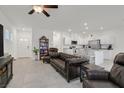 Open concept living room, adjacent to kitchen, features tile flooring and recessed lighting at 392 Canary Song Dr, Henderson, NV 89011