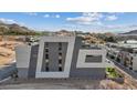 Modern multi-story home exterior showing contemporary architectural design with geometric shapes and gray and white color scheme at 40 Heron Harbour Dr, Henderson, NV 89011