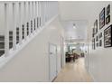 Bright hallway featuring a staircase and several framed pictures at 4030 Midnight Crest Ave, North Las Vegas, NV 89031