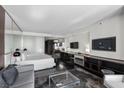 Sleek bedroom boasts dark wood floors, modern decor, and a comfortable sitting area at 4381 W Flamingo Rd # 3809, Las Vegas, NV 89103