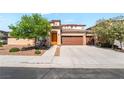 Charming home featuring a well-maintained front yard and a spacious three-car garage at 512 Los Dolces St, Las Vegas, NV 89138