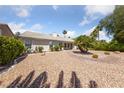 Large backyard offering desert landscaping with palm trees for relaxing and entertaining at 5232 Saranac Rd, Las Vegas, NV 89130