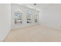 Light-filled bedroom with large windows and plush carpeting providing comfort and style at 5232 Saranac Rd, Las Vegas, NV 89130