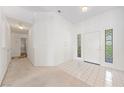 Bright entryway with white tile flooring, decorative glass blocks, and access to adjacent rooms at 5232 Saranac Rd, Las Vegas, NV 89130