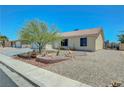 Attractive single-story home with desert landscaping, a brick planter, and a two-car garage at 5236 Krista Alethea St, North Las Vegas, NV 89031