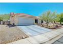 Inviting single-story home with a two-car garage and low-maintenance desert landscaping at 5236 Krista Alethea St, North Las Vegas, NV 89031