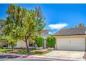 Charming single story home with desert landscaping, an attached garage, and a front gate at 5713 Whiteridge Ave, Las Vegas, NV 89107