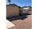 Back of the house with a covered patio and xeriscaping at 6196 W University Ave, Las Vegas, NV 89103