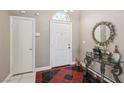 Inviting entryway featuring a colorful tiled floor, decorative mirror, and a white front door at 628 Bay Bridge Dr, North Las Vegas, NV 89032