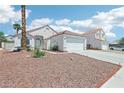 Charming single-story home with a well-manicured desert front yard and a two-car garage at 628 Bay Bridge Dr, North Las Vegas, NV 89032