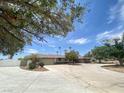 Ranch-style home featuring circular driveway, desert landscaping, and tall palm trees at 6315 Eldora Ave, Las Vegas, NV 89146