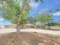 Single-story home with well-manicured front lawn, long driveway, and mature shade trees at 6315 Eldora Ave, Las Vegas, NV 89146