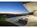 Resort-style backyard with infinity pool, fire pit, and city views at sunset at 641 Majestic Rim Dr, Henderson, NV 89012