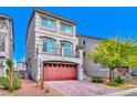 Attractive home featuring a bright red garage door, second-story balcony, manicured landscaping, and inviting curb appeal at 7032 Steele Canyon St, Las Vegas, NV 89118