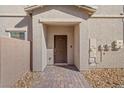 Inviting entrance with a covered doorway and brick pathway leading to the front door at 7051 Denio Island St, North Las Vegas, NV 89084