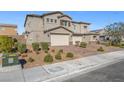 Charming stucco two-story home with a brick driveway and well-maintained landscaping at 7051 Denio Island St, North Las Vegas, NV 89084