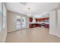 Spacious kitchen with stainless steel appliances, tile flooring, and natural light through the back patio doors at 708 Point Bluff St, Henderson, NV 89002