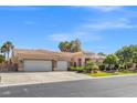 Spacious house with a three-car garage, desert landscaping, and a well-maintained exterior at 7411 Brittlethorne Ave, Las Vegas, NV 89131