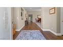 Inviting foyer featuring hardwood floors leading into the dining room and main living areas at 7411 Brittlethorne Ave, Las Vegas, NV 89131