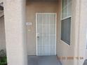 Close-up of the front entrance with white security door and address number 411 at 75 N Valle Verde Dr # 411, Henderson, NV 89074