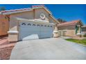 Close-up of the two-car garage and front yard showcasing the home's curb appeal at 7824 Faith Ct, Las Vegas, NV 89131